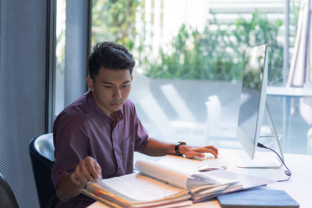istock Malay man focusing on work Stock Photo 1399313569