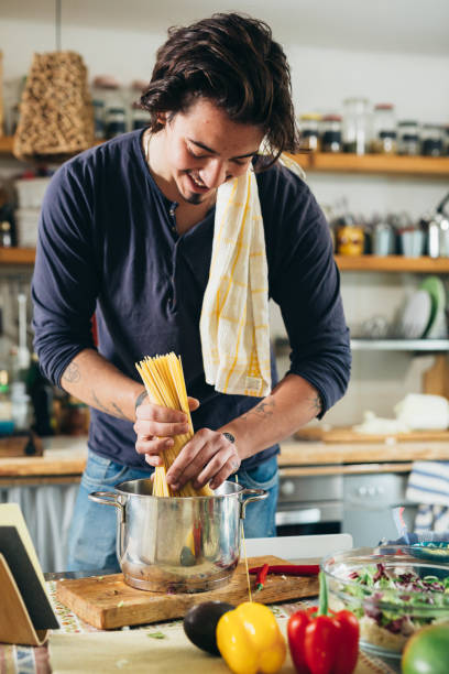 istock man preparing food inhome kitchen 1399314786
