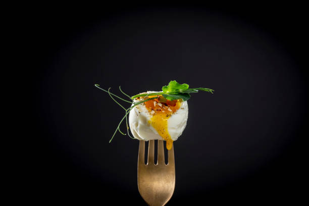 soft-boiled egg with pea microgreens on a fork on a black background, breakfast time, copy space - poached egg imagens e fotografias de stock