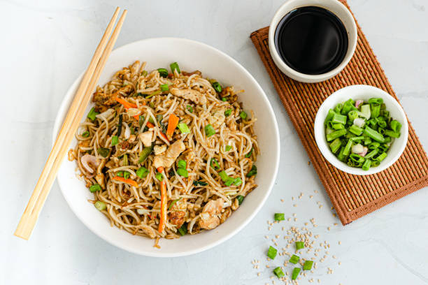 Chow Mein Noodles with Chicken and Veggies Served with Soy Sauce and Scallion Top Down Photo stock photo