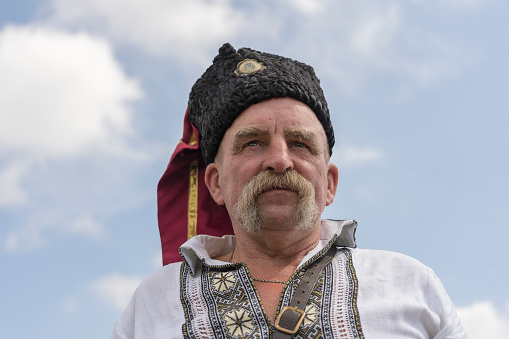 Slavuta, Ukraine - august 01, 2021 : Ukrainian old man in national costumes take part in the Ethno-eco festival Kolodar in the city of Slavuta, Ukraine