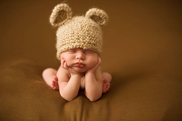 istock A newborn baby sleeping in a brown knit hat with ears 139931995