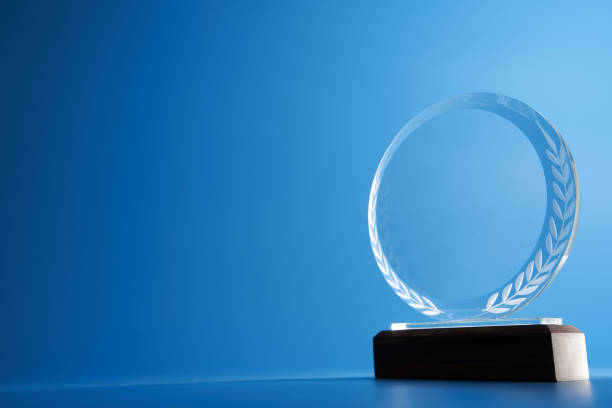 istock crystal trophy against blue background 1399326791
