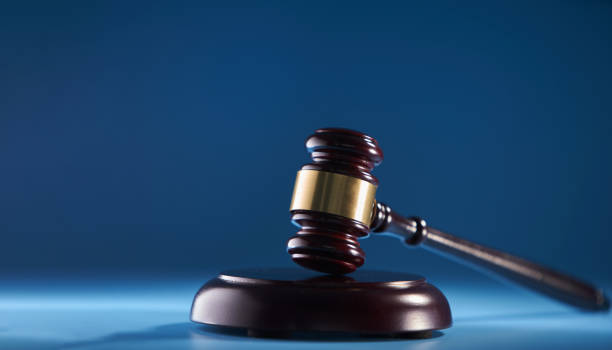 istock gavel hammer against blue background 1399326797