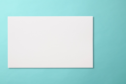 Blank paper on light blue background  with clipping path.