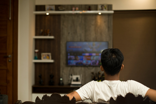 Young boy watching smart TV at home