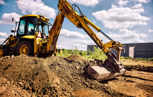 istock Excavator at house construction site - digging foundations for modern house 1399329133