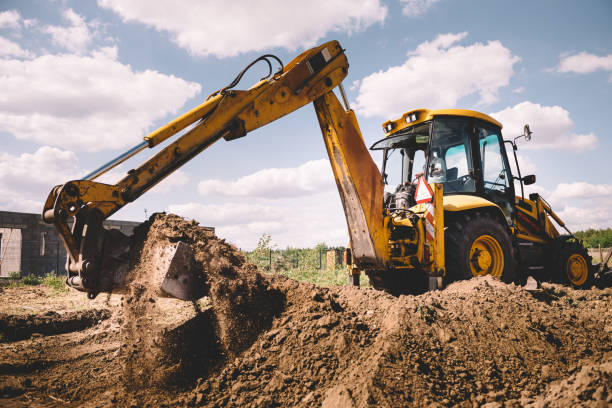 istock Excavator at house construction site - digging foundations for modern house 1399329150