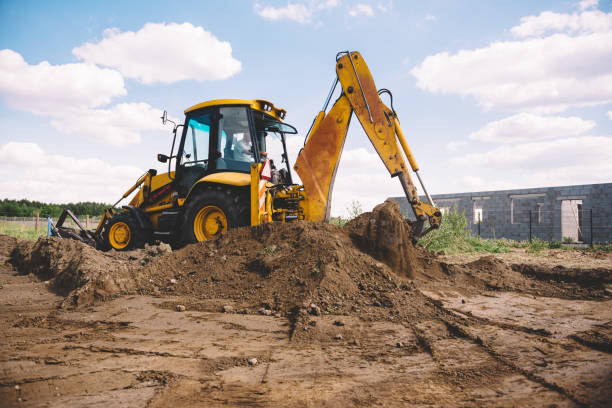istock Excavator at house construction site - digging foundations for modern house 1399329164