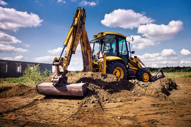 istock Excavator at house construction site - digging foundations for modern house 1399329176