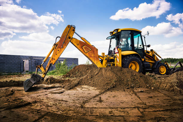 istock Excavator at house construction site - digging foundations for modern house 1399329204