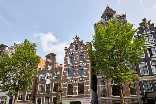 Old Church Oude Kerk the oldest building in De Wallen Amsterdam, Netherlands against blue sky