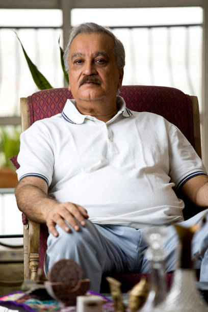 istock Senior man relaxing on chair at home 1399333370