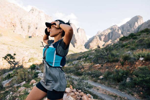 istock Female hiker standing in wild terrain looking on mountains 1399334692