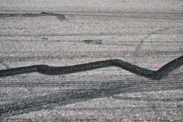 istock Black tire marks on the road 1399335033