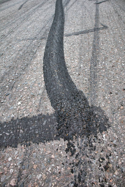 istock Black tire marks on the road 1399335035