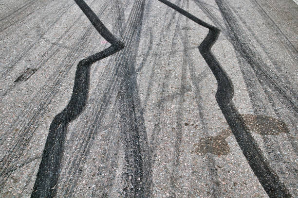 istock Black tire marks on the road 1399335037