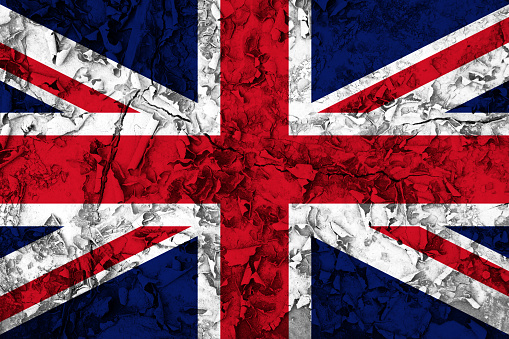 United Kingdom flag on old cracked textured wall, background. Patriotic grunge background. National flag of Great Britain
