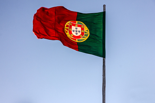Portugal flag on the wind, blue sky