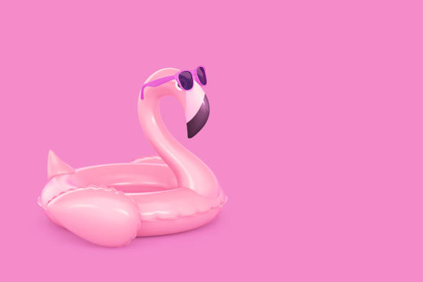 istock Inflatable flamingo in sunglasses on pink background 1399338919