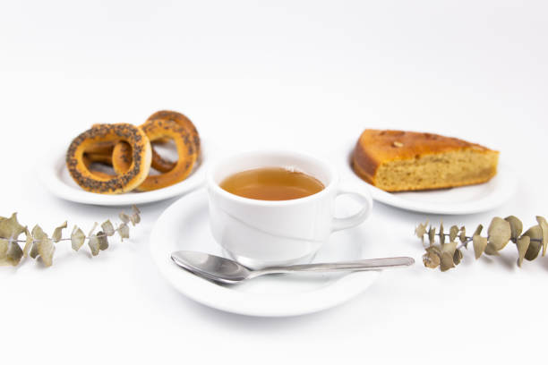 white tea set with teapot tea and saucers and pie for breakfast