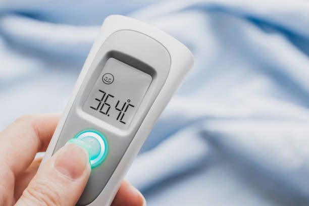 istock Hand holding ir thermometer with normal temperature. close up. Infrared temperature measuring device. Healthcare home action. Non-contact thermometer 1399339853