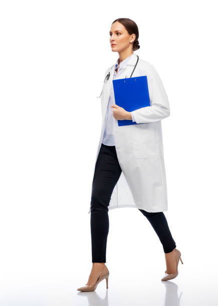 istock female doctor walking with clipboard 1399339981