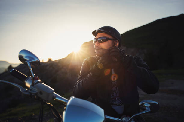 Close up shot of motorcyclist on sunset.