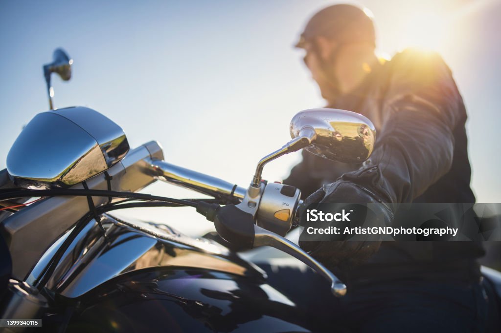 Close up shot of motorcyclist. Close up shot of motorcyclist on sunset. Motorcycle Stock Photo