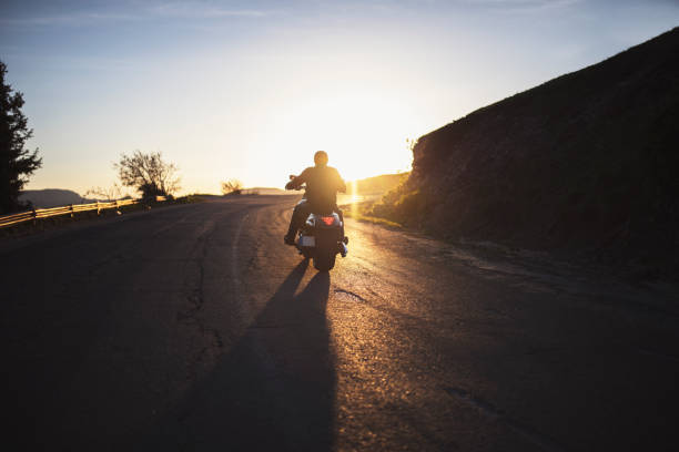 istock Motorcyclist on the road on sunset. 1399340116