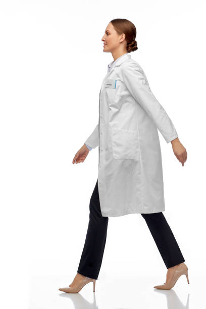 istock smiling female doctor or scientist walking 1399340190