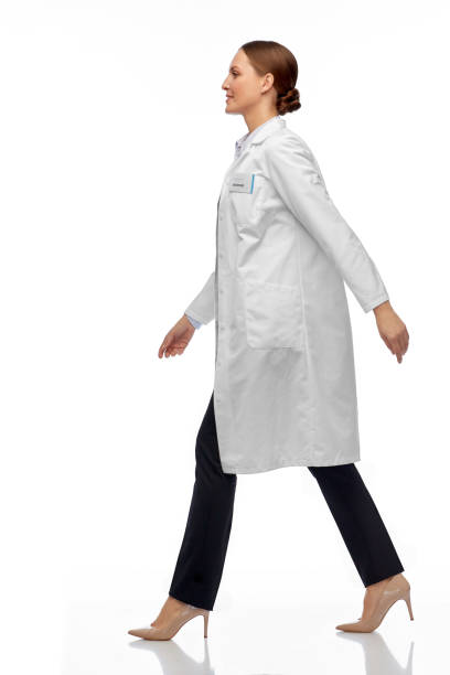 smiling female doctor or scientist walking stock photo
