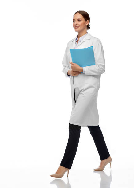 istock female doctor or scientist walking with folder 1399340605