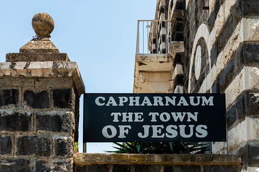 Sign at the entrance to Capernaum on which is written 