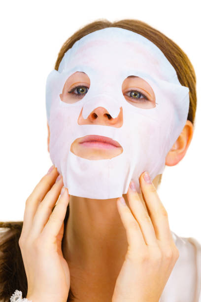istock Woman applying sheet mask on face 1399344719