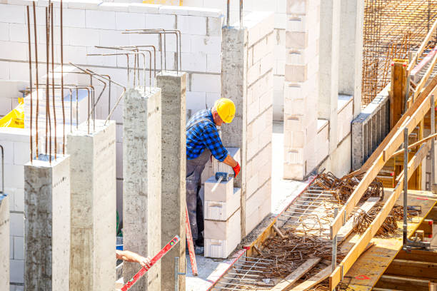 istock The bricklayer builds a wall of hollow bricks 1399344939