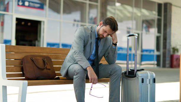 istock Pensive businessman is waiting at train station alone 1399344986