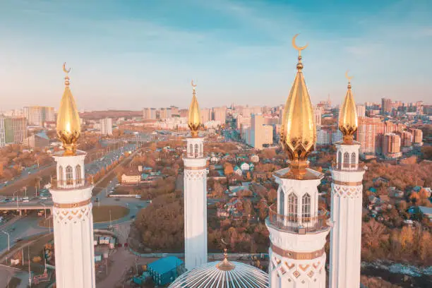 Photo of Aerial unusual view of minarets of a majestic mosque. Muslim and religion architecture concept