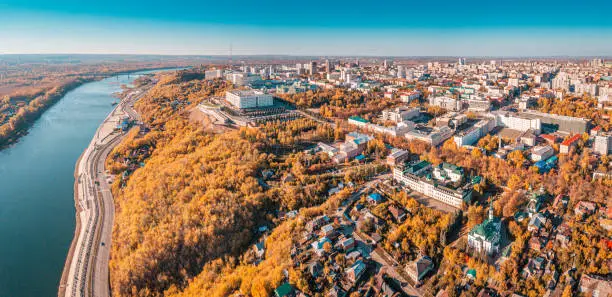 Photo of Aerial view of the river bank and central district and downtown of the city with administrative and government buildings at scenic golden autumn