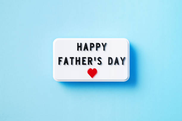 istock Happy Father's Day Written White Lightbox Sitting On Blue Background 1399347061