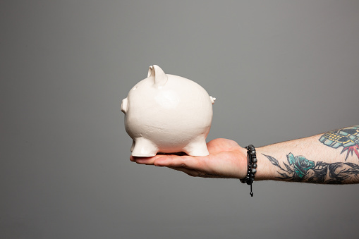 Man hand holding piggy bank. Save money and financial investment