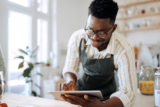 istock Young handsome man taking order for smoothies at his domestic kitchen 1399348805