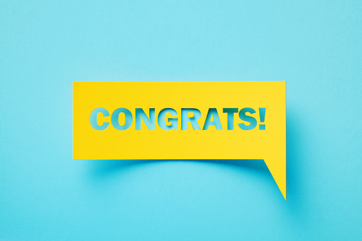 Congrats written rectangular shaped yellow chat bubble sitting on turquoise background. Horizontal composition with copy space.