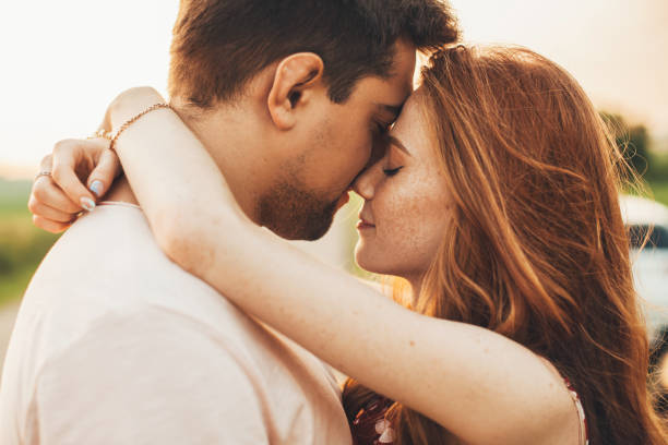 istock Side view portrait of a cheerful romantic couple posing standing closeness outdoors. Beautiful portrait. Close-up. 1399349727
