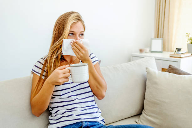 istock Ill girl sneezing with runny nose. 1399349803