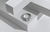 Diamonds ring on geometric white background with copy space