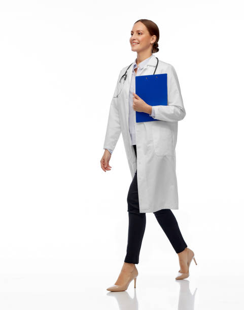 istock happy smiling female doctor walking with clipboard 1399351413