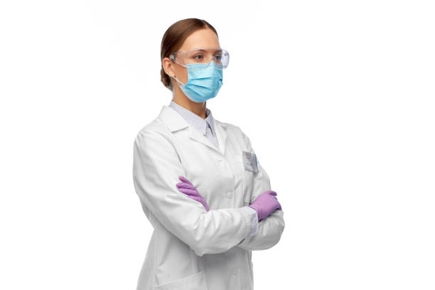 female scientist in medical mask and goggles stock photo