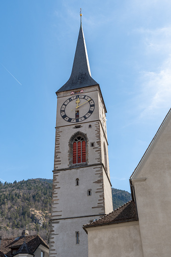 Chur, Switzerland, April 11, 2022 Bell tower of the historic old saint Martin church in the city center