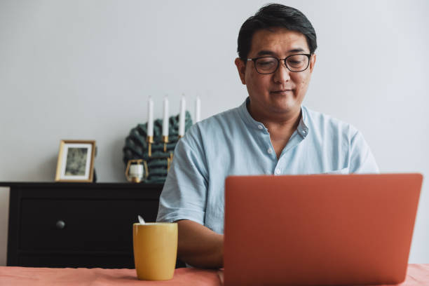 istock Mature man working at home using laptop in dining room. 1399353321